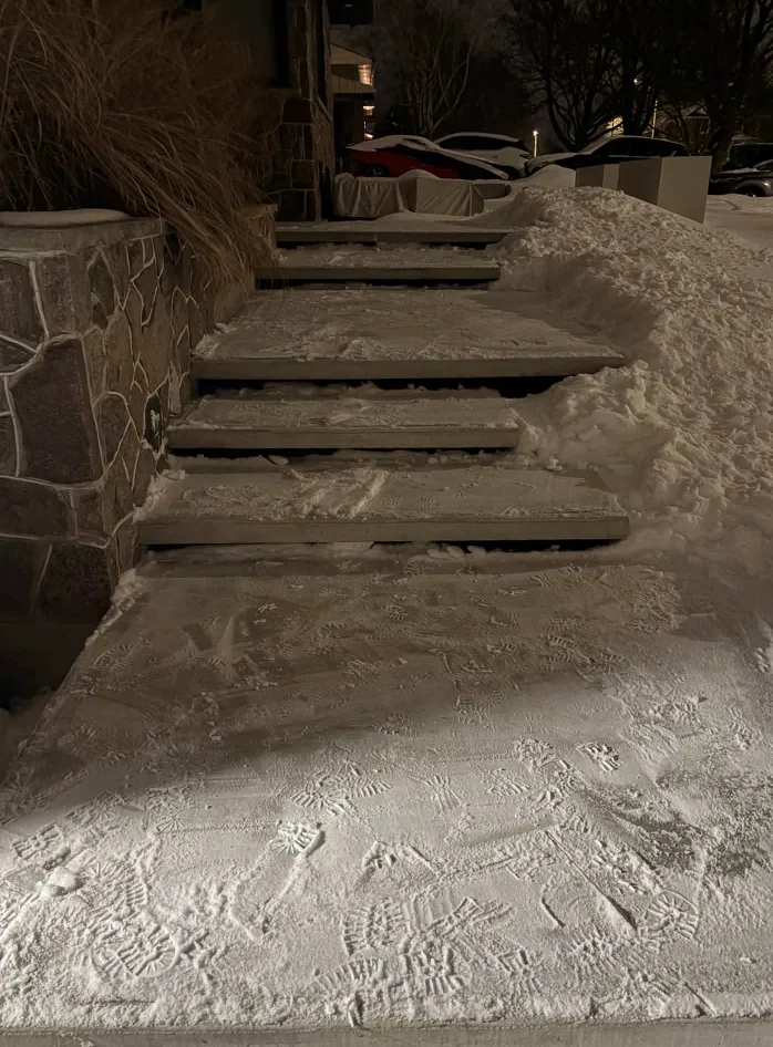 Outdoor steps and adjoining path after snow clearing at night in Durham Region, Ontario